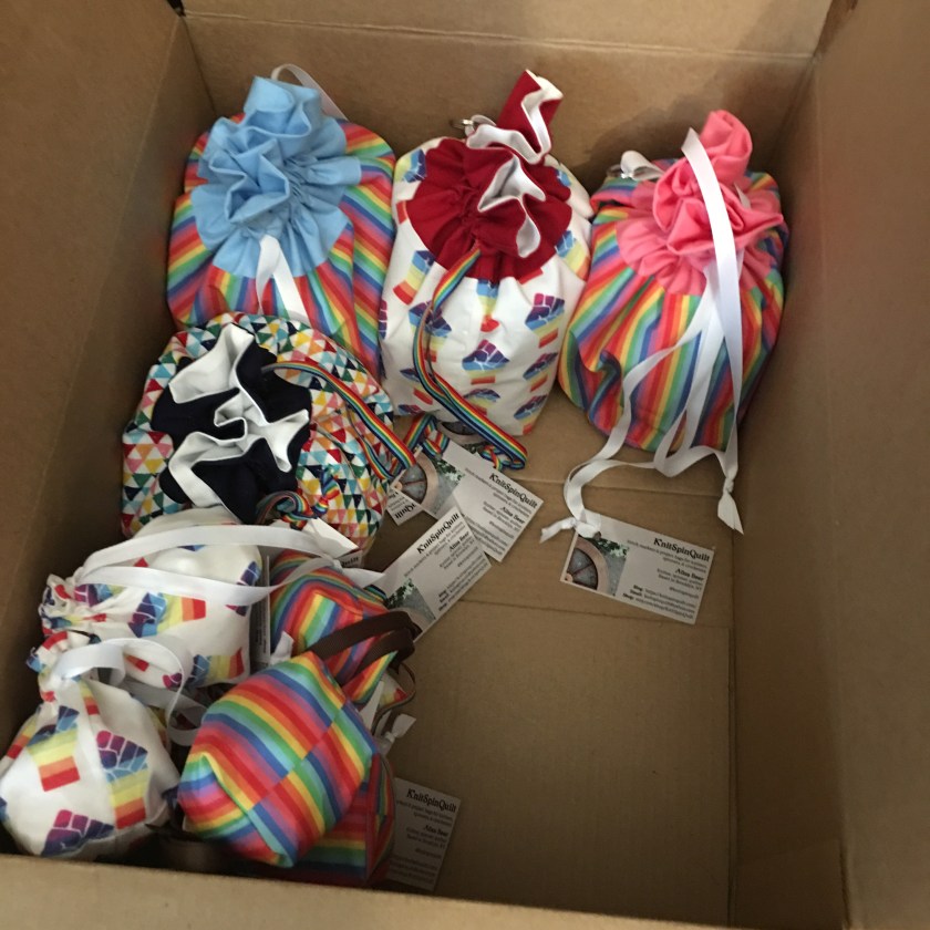 Box of rainbow drawstring bags