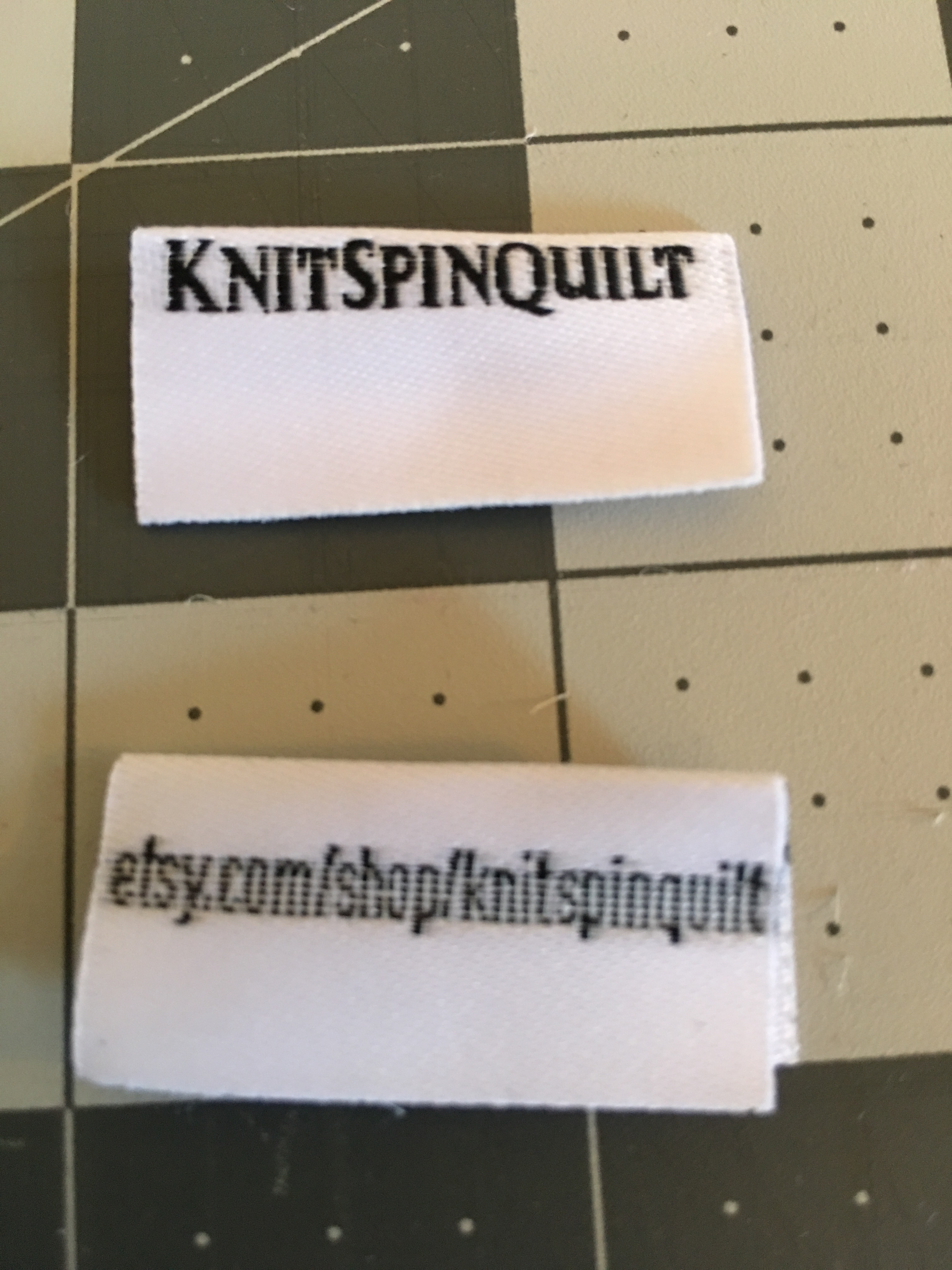 Two woven labels reading KnitSpinQuilt and giving the KSQ shop URL